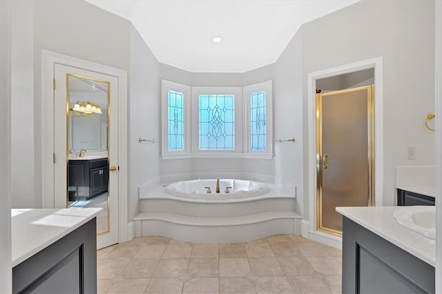 bathroom featuring a bath, vanity, tile patterned flooring, and a stall shower