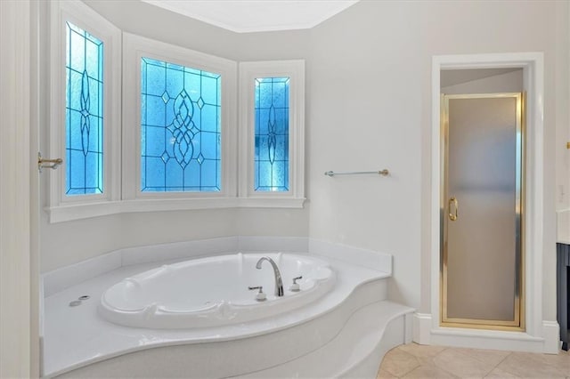 full bath featuring a garden tub, tile patterned flooring, and a shower stall