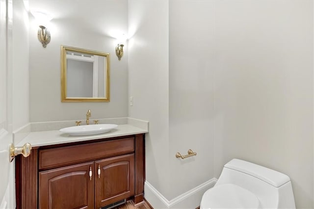 bathroom with toilet and vanity