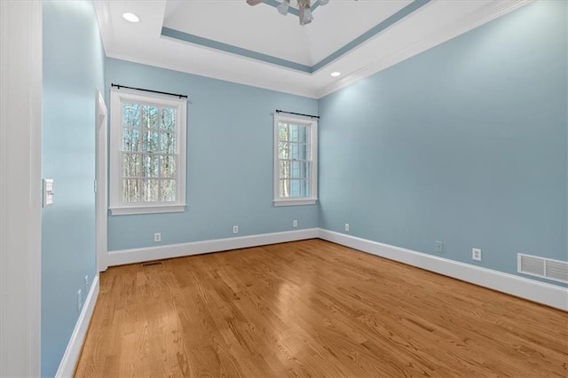 empty room featuring wood finished floors, a wealth of natural light, and baseboards