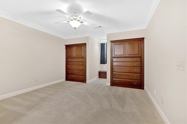 unfurnished bedroom featuring baseboards, visible vents, light colored carpet, and crown molding