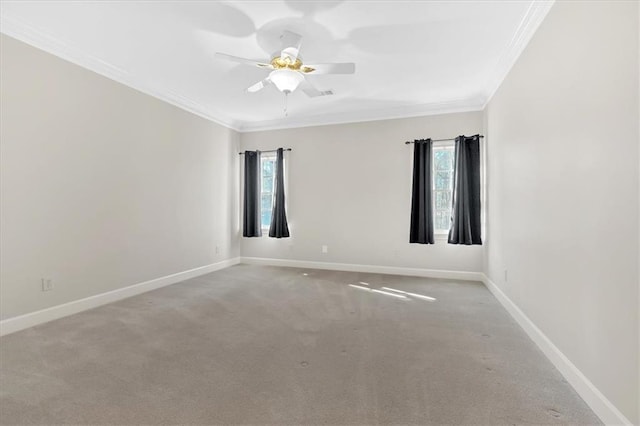 spare room with carpet, a wealth of natural light, crown molding, and a ceiling fan