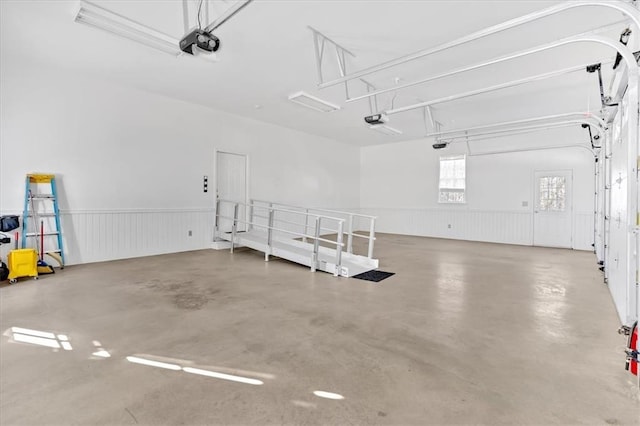 garage featuring wainscoting and a garage door opener