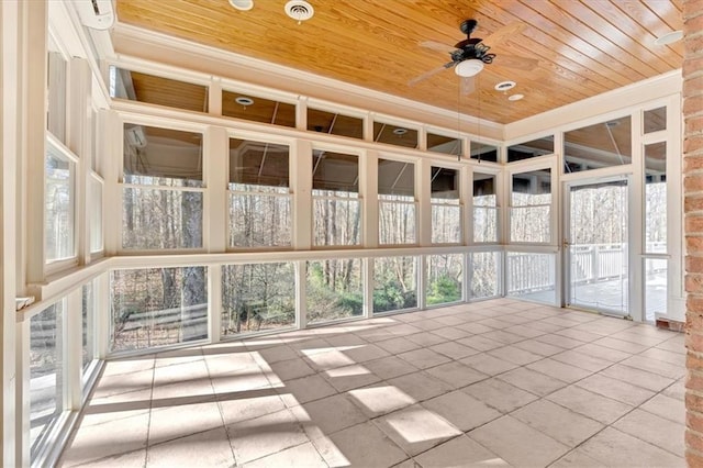 unfurnished sunroom with ceiling fan