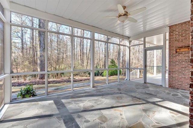 unfurnished sunroom with ceiling fan