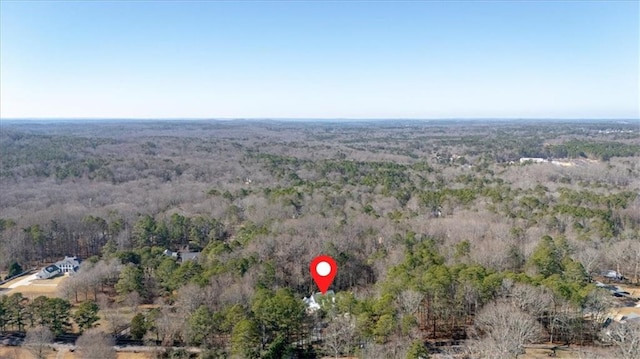 aerial view featuring a wooded view