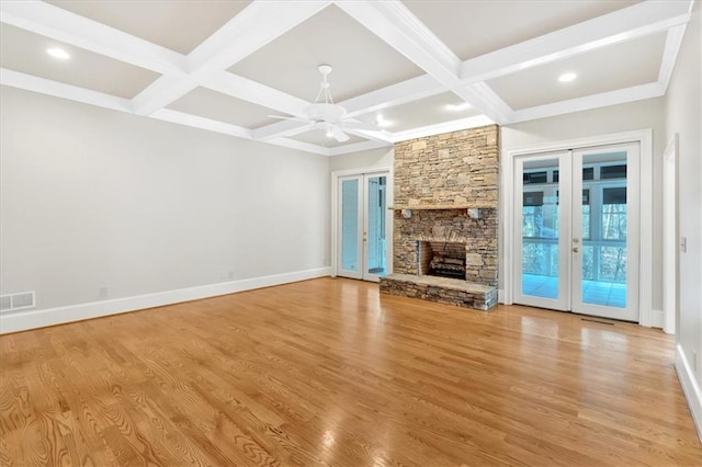 unfurnished living room with coffered ceiling, visible vents, french doors, beam ceiling, and baseboards