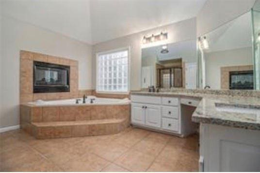 4519 Mossey Dr, Lithonia, GA 30038 - full bathroom with a fireplace, tile patterned flooring, and a garden tub