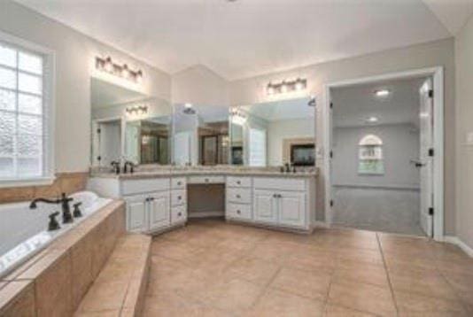 4519 Mossey Dr, Lithonia, GA 30038 - bathroom with tile patterned floors, a bath, and plenty of natural light