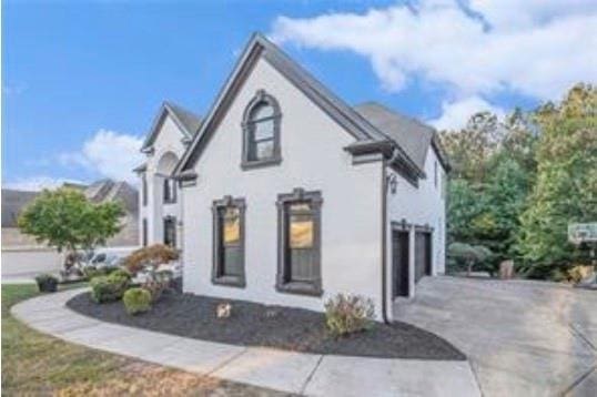 4519 Mossey Dr, Lithonia, GA 30038 - view of property exterior with driveway, a garage, and stucco siding