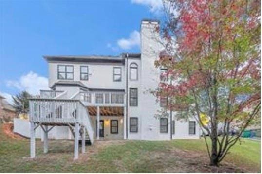 4519 Mossey Dr, Lithonia, GA 30038 - back of house with a wooden deck, a chimney, and a lawn