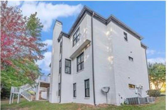 4519 Mossey Dr, Lithonia, GA 30038 - view of home's exterior featuring a chimney and stucco siding