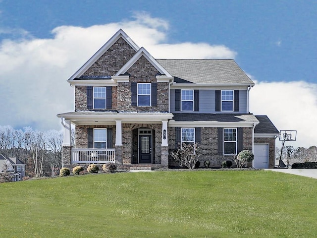 craftsman-style house with an attached garage, a porch, concrete driveway, and a front lawn