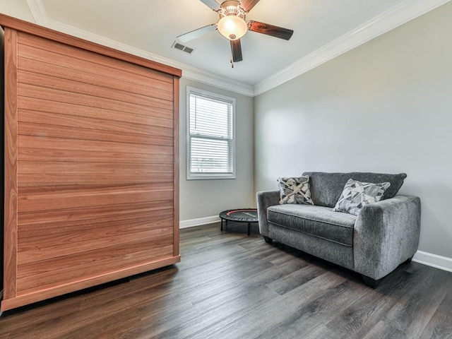 living area with visible vents, baseboards, crown molding, and dark wood-type flooring