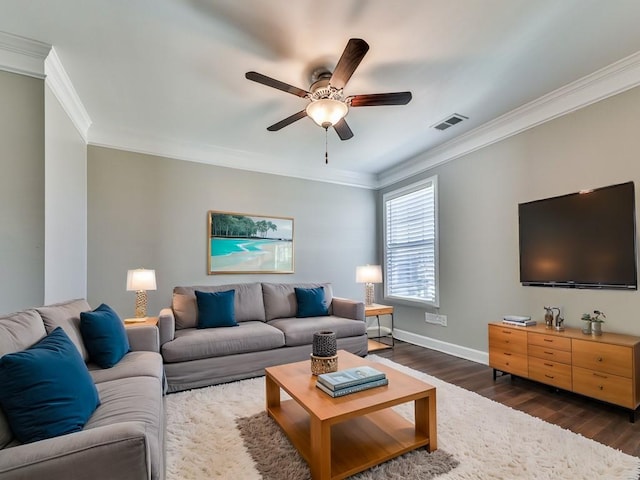 living room featuring dark wood finished floors, visible vents, baseboards, and ornamental molding