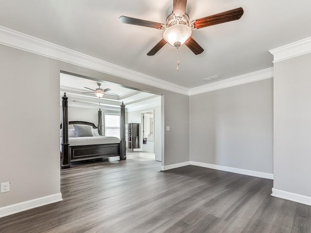 unfurnished bedroom with baseboards, ornamental molding, and dark wood-style flooring