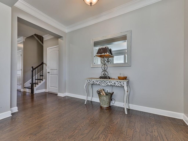 interior space with crown molding, stairway, wood finished floors, and baseboards