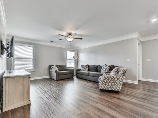 living room with visible vents, a ceiling fan, dark wood-style floors, crown molding, and baseboards