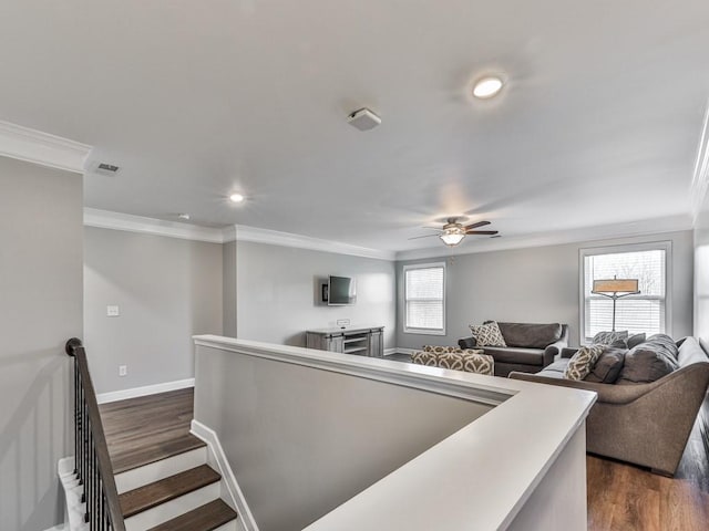 living area featuring baseboards, ornamental molding, recessed lighting, a ceiling fan, and dark wood-style flooring