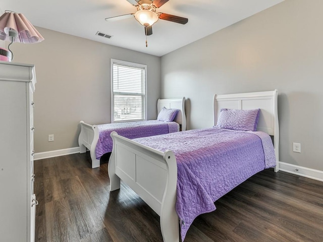 bedroom featuring visible vents, baseboards, and dark wood-style floors