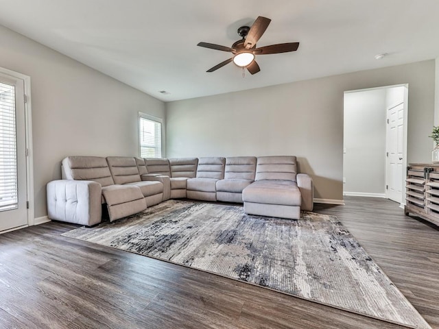 living room featuring visible vents, wood finished floors, baseboards, and ceiling fan