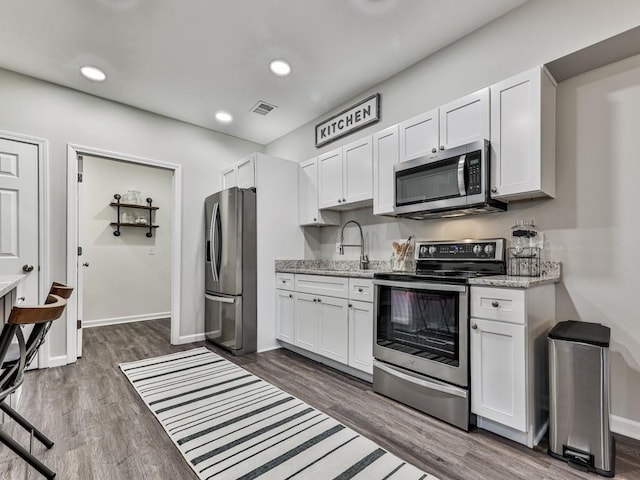 kitchen featuring a sink, visible vents, appliances with stainless steel finishes, and white cabinets