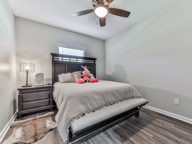 bedroom featuring ceiling fan, baseboards, and wood finished floors