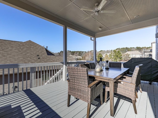 wooden terrace with outdoor dining space and a ceiling fan