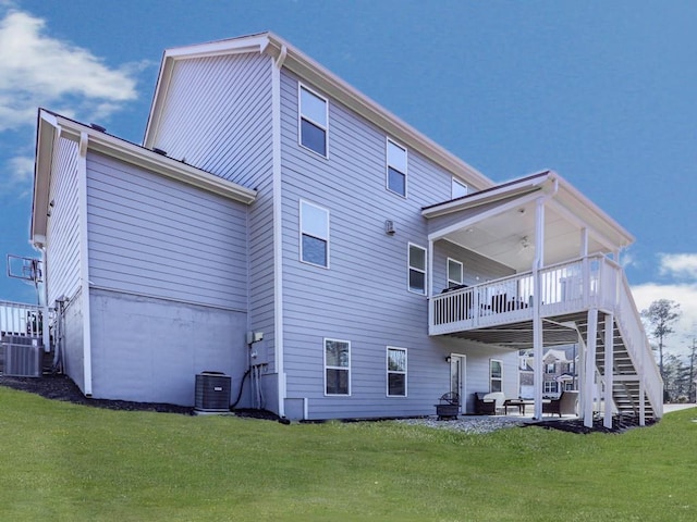 back of property featuring a yard, a patio, central AC, and stairway