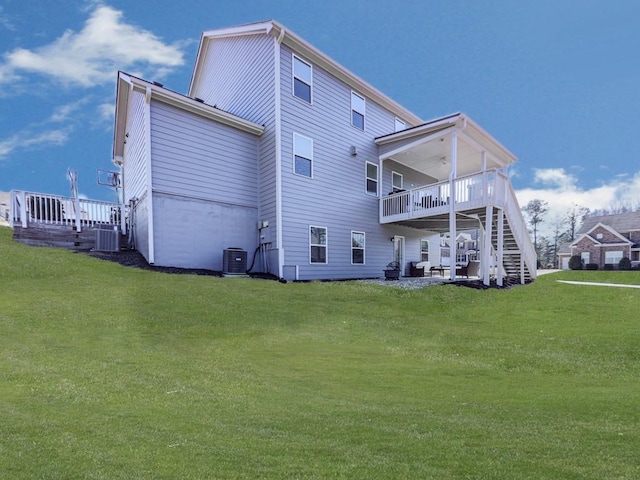 back of house featuring stairway, cooling unit, and a yard