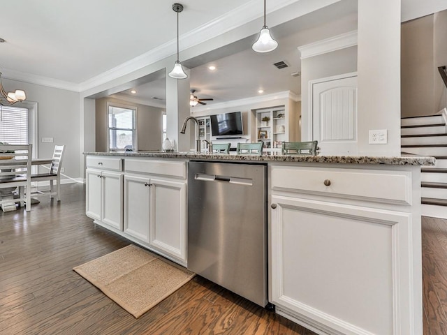 kitchen with light stone counters, visible vents, dark wood-type flooring, dishwasher, and crown molding