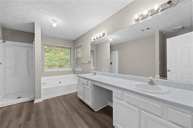 470 Piney Way SW, Atlanta, GA 30331 - bathroom with wood finished floors, a garden tub, double vanity, a textured ceiling, and a shower