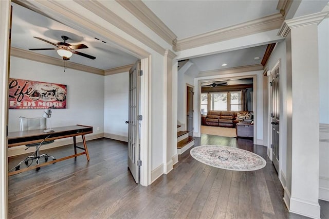 corridor featuring hardwood / wood-style flooring, ornamental molding, and decorative columns