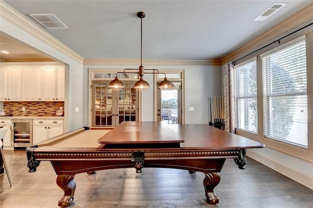 game room with light hardwood / wood-style flooring, french doors, billiards, crown molding, and wine cooler