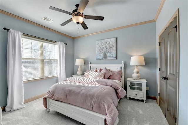 bedroom featuring ceiling fan, crown molding, and light colored carpet