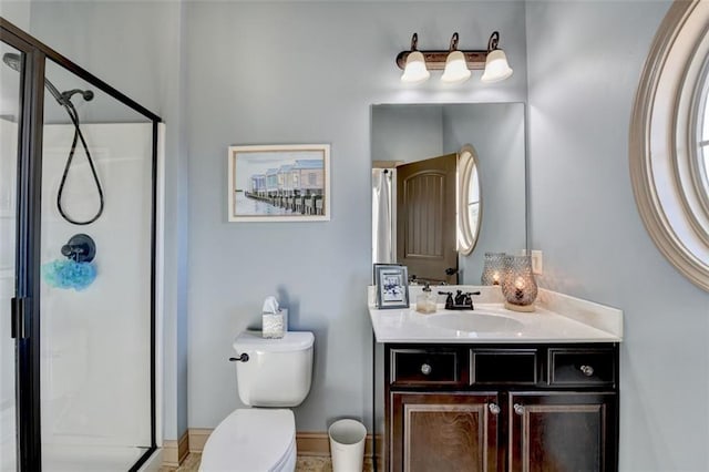 bathroom featuring vanity, toilet, and walk in shower