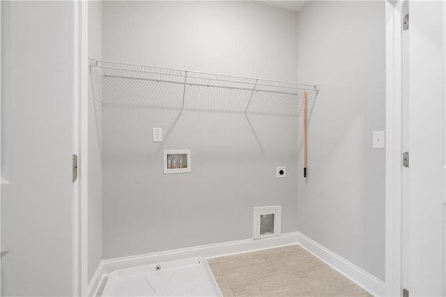 laundry area featuring gas dryer hookup, laundry area, washer hookup, baseboards, and electric dryer hookup