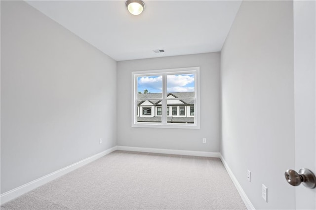 unfurnished room featuring carpet, visible vents, and baseboards