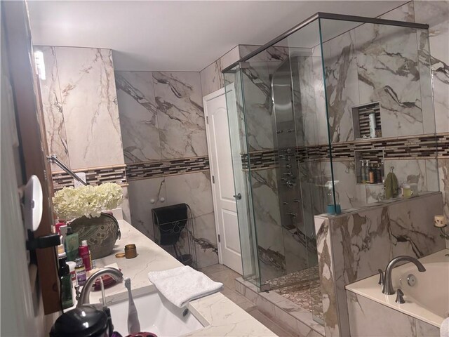 2610 Gadsen Walk, Duluth, GA 30097 - bathroom featuring a garden tub, tile walls, a marble finish shower, and stone wall
