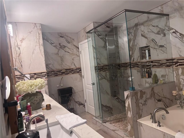 2610 Gadsen Walk, Duluth, GA 30097 - full bath with a marble finish shower, a garden tub, marble finish floor, vanity, and stone wall