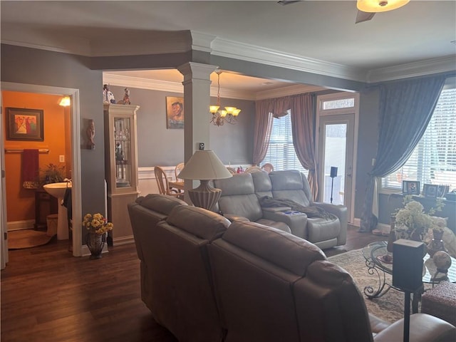 2610 Gadsen Walk, Duluth, GA 30097 - living area featuring dark wood-style floors, ornamental molding, a notable chandelier, and ornate columns