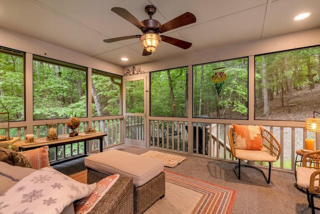 sunroom featuring ceiling fan