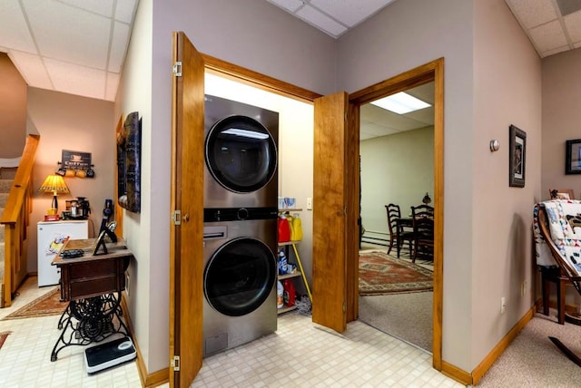 laundry room with stacked washing maching and dryer