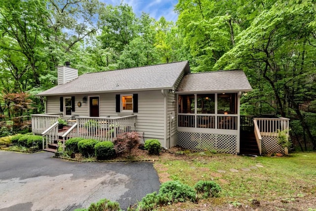 view of front of property with a deck and a sunroom