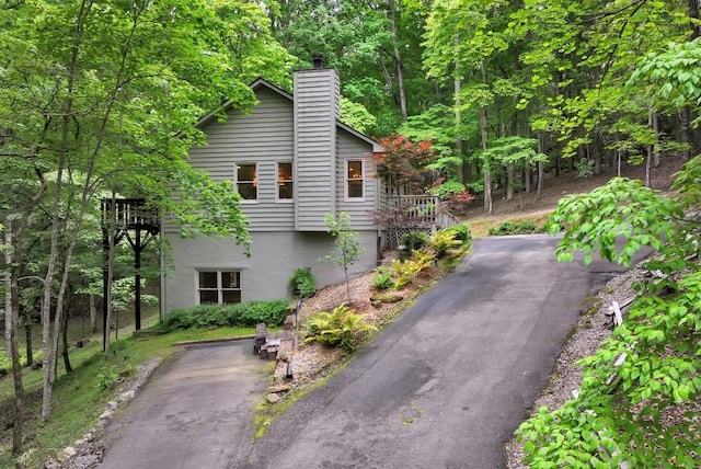 view of property exterior with a deck