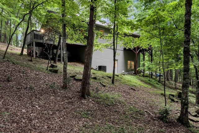 exterior space featuring a wooden deck and central AC unit