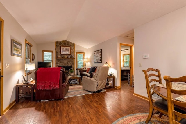 living room featuring lofted ceiling, a fireplace, and dark hardwood / wood-style floors