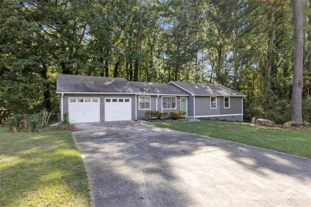 ranch-style home with a garage, a front yard, and driveway