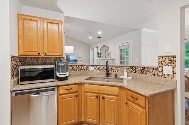2277 Lazy Days Rd, Dacula, GA 30019 - kitchen featuring appliances with stainless steel finishes, a sink, decorative backsplash, vaulted ceiling, and light stone countertops