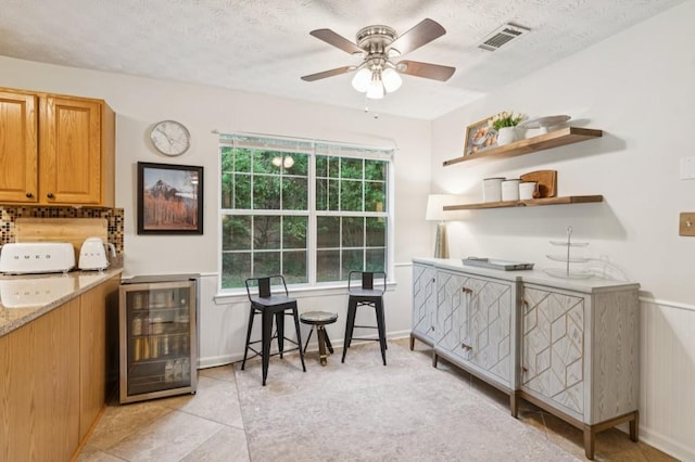 2277 Lazy Days Rd, Dacula, GA 30019 - interior space featuring beverage cooler, a ceiling fan, light tile patterned floors, a textured ceiling, and tasteful backsplash
